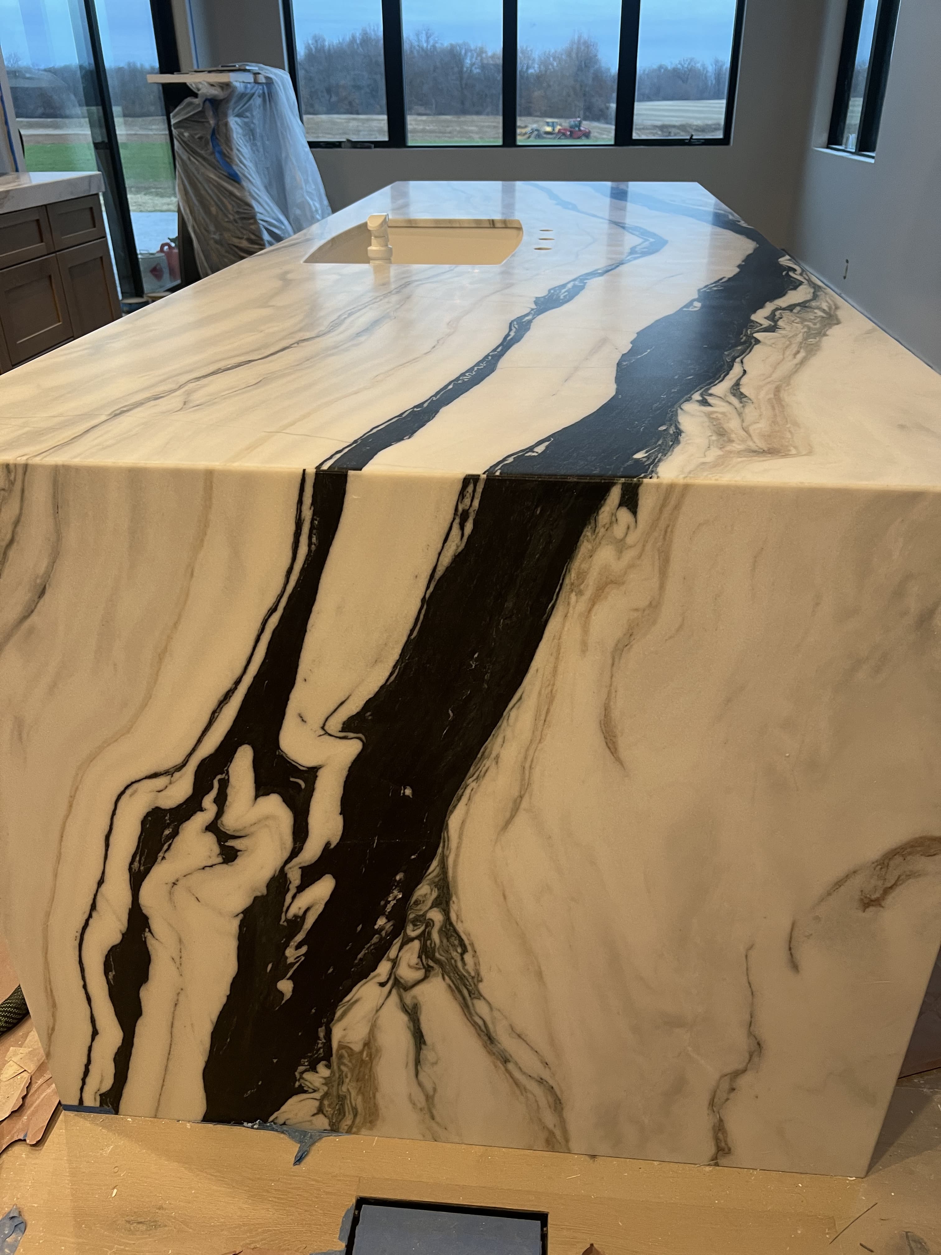 Black and white marble waterfall island