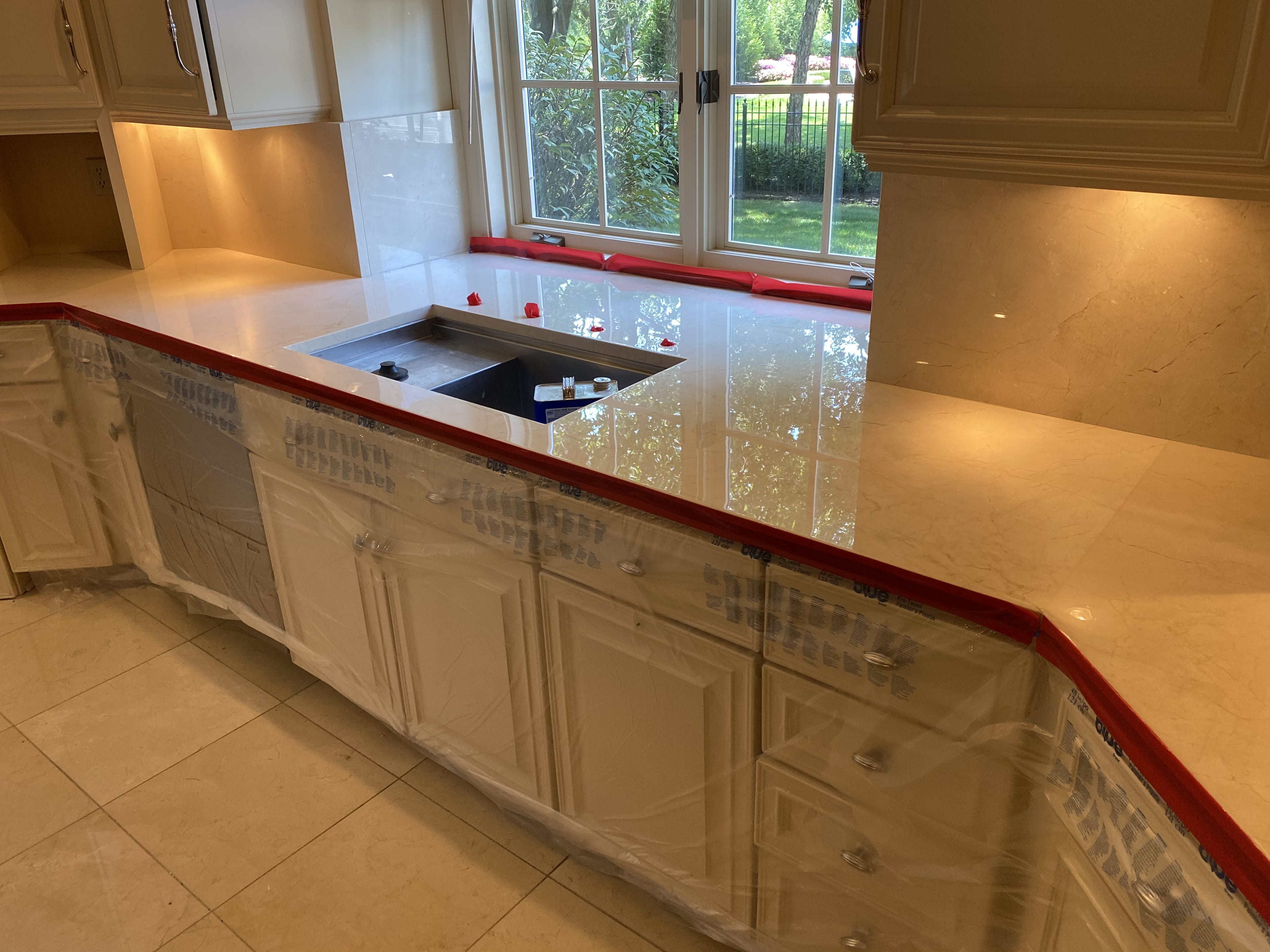 Marble kitchen counters, taped off and polished